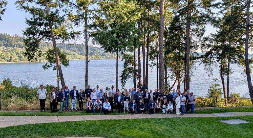CMMC-PNW 2026 attendees at the happy hour on the waterfront lawn overlooking Agate Passage